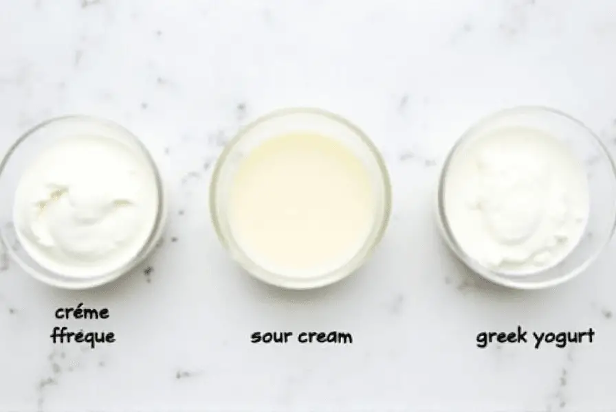 Crème fraîche, sour cream, and Greek yogurt in glass bowls.