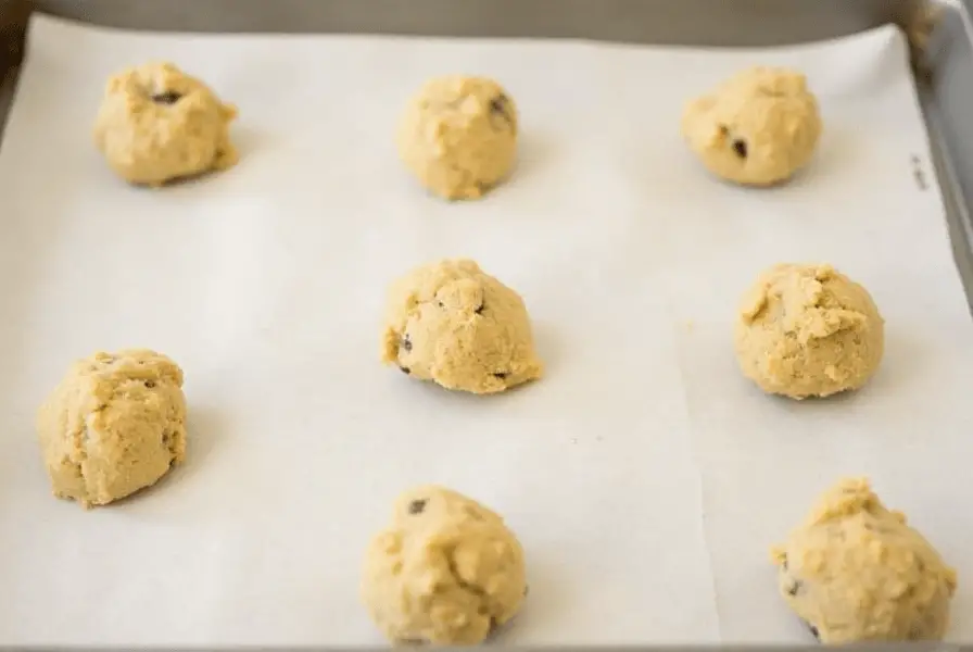 Allergen-free cookie dough portions on a baking tray.